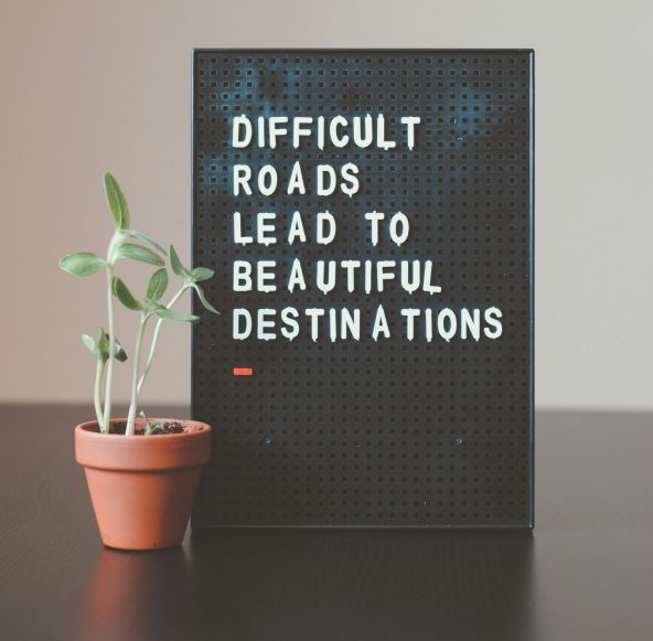 Blackboard with white text saying difficult roads lead to beautiful destinations